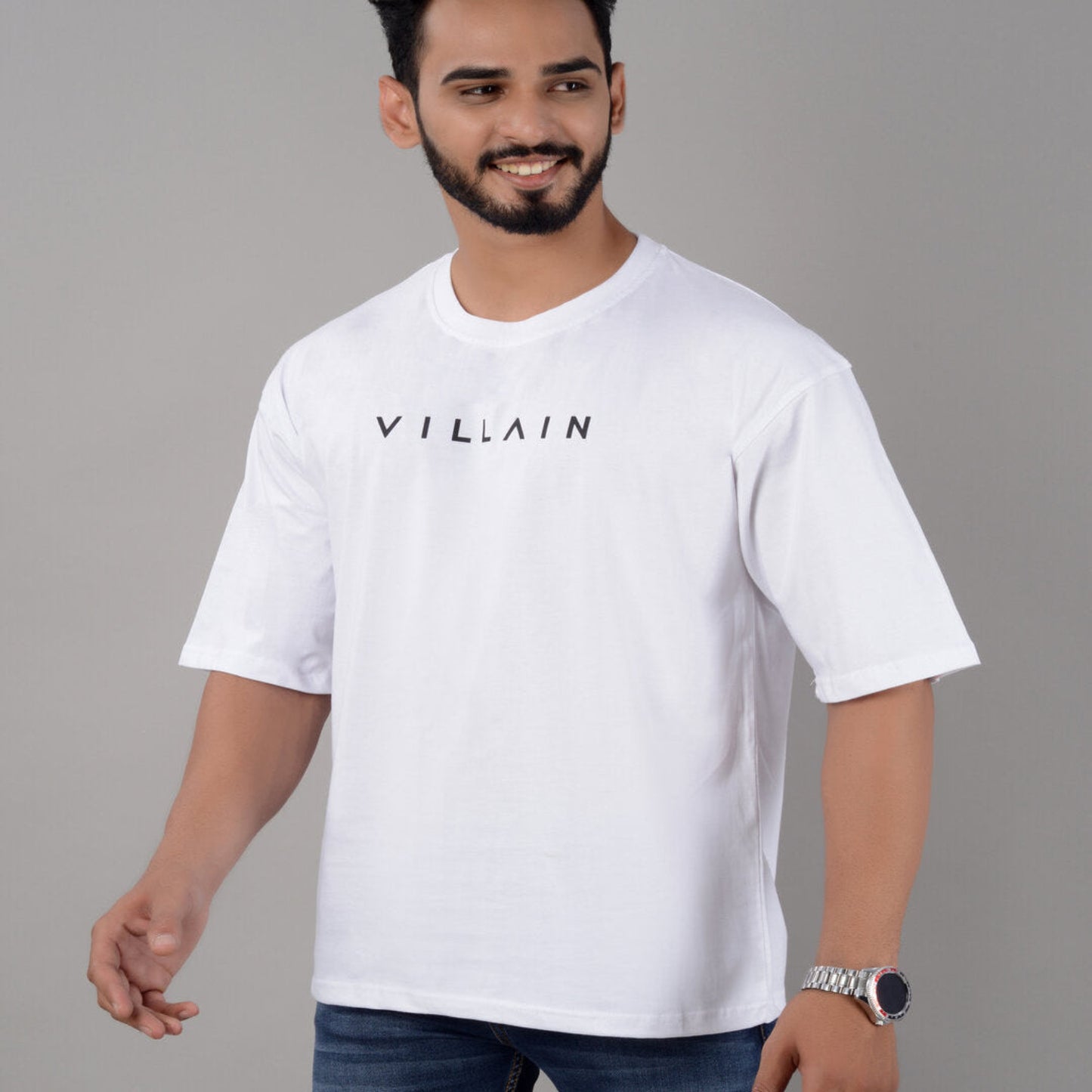 Man wearing a white t-shirt with 'VILLAIN' text on a gray background